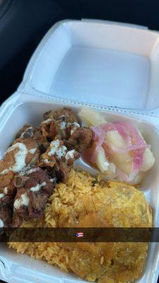 plate of: arroz con gandules, pollo frito, yuca, and tostones