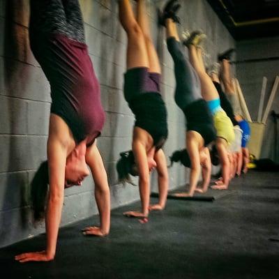 The ladies practicing hand stand holds!