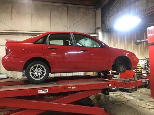 Inspecting a vehicle after a curb shot and then checking the alignment to make sure it's safe for the customer.