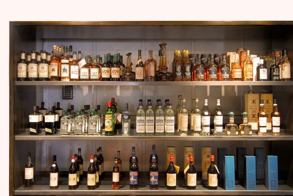 Inside a portal to an abandoned freight elevator shaft, we had custom metal shelves built to feature our craft spirits seleciton