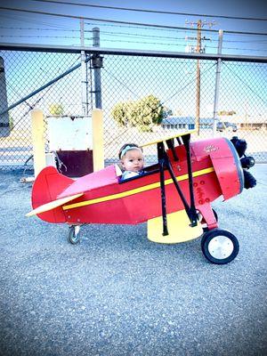 Granddaughter driving kids plane.