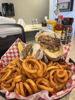 Philly Cheesesteak and curly fries. Surprisingly spicy!