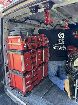 Mario Castillo Electric vans restocking supplies in preparation for upcoming projects.