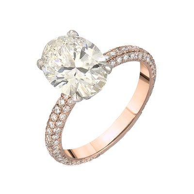 Oval diamond set in platinum and rose gold pave custom engagement ring.