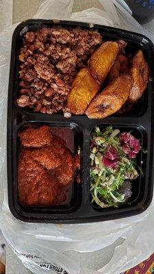 Purple rice and beans, fried plantains, goat stew and salad