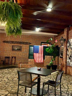 Indoor patio complete with ferns, fans, and air conditioning.