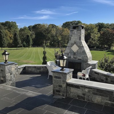 Two level outdoor kitchen patio faced with thin stone and caped off with 2" granite treads.