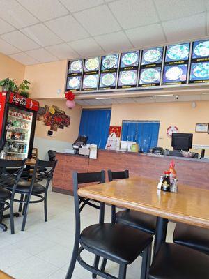 Front counter, dining area, menu board.