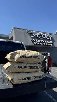 The ABG Building Sign, Showcasing we offer grilled catering items cooked with mesquite charcoal.