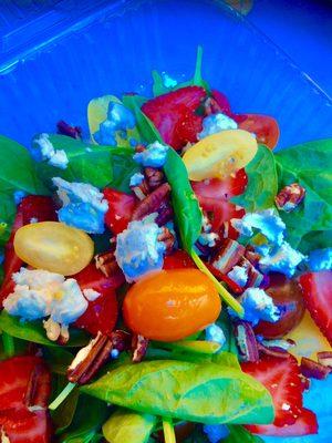 Spinach and strawberry salad with goat cheese, toasted pecans, heirloom cherry tomatoes and honey lemon vinaigrette