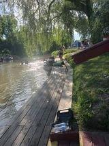 Campers on dock of river