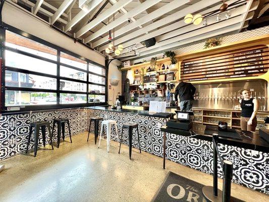 Front counter and bar seating. Windows roll up to allow air flow.