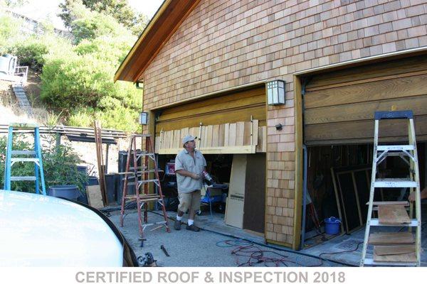 Owner Ron Williams installs wood shingle siding on rolling garage door. Stockton's best roofer! #roof #roofing #contractor #companies