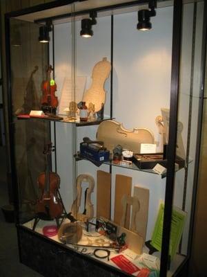 a display of violin parts and wood