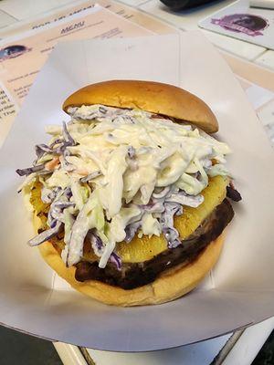 Jerk chicken sandwich: Chopped jerk chicken, grilled pineapple, and house-made coleslaw on a toasted brioche bun.