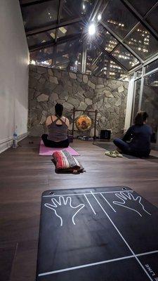 Outside yoga room with window ceiling. Fits about 3 days across the room and 3-4 rows back.