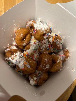 Box of Mini Donuts w/ powdered sugar, vanilla icing and sprinkles!