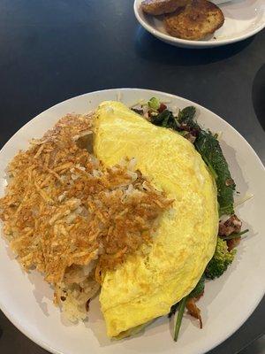 3 egg omelette with cheddar, Swiss, broccoli, spinach and bacon and a side of hash! Delicious.