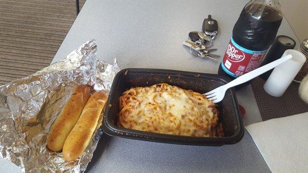 Baked Spaghetti with two bread sticks