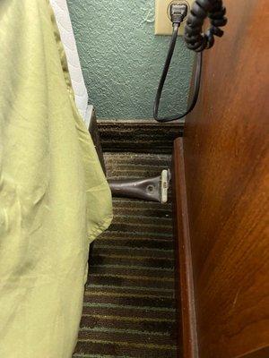 metal bar sticking out from under bed