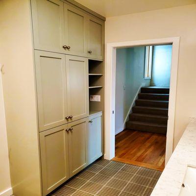 Phinney Ridge Bathroom Remodel. Moved exterior wall to accommodate a larger vanity with 2 sinks and a floor to ceiling cabinet.