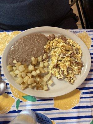 Breakfast plate with sausage & eggs, refried beans, Country potatoes & flour tortillas.