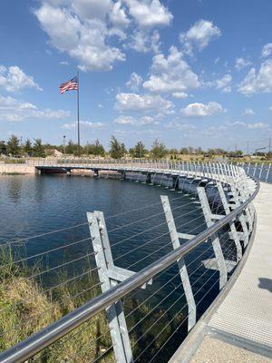 Walkway over pond with cascading water feature