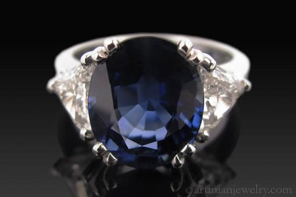 Nearly 5 carat blue sapphire in handmade mounting with trillion cut diamonds