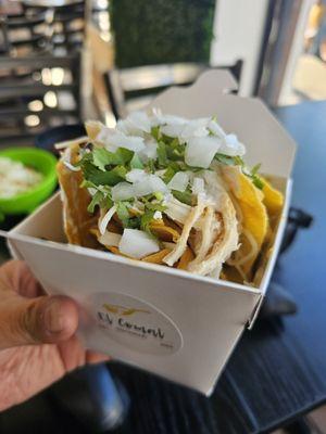 Chilaquiles verdes topped with chicken and salsa Verde.