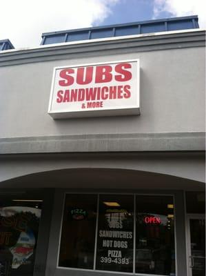 Subs, Sandwiches and More storefront sign