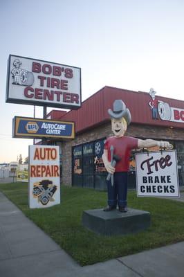 Street side mascot with company sign in background