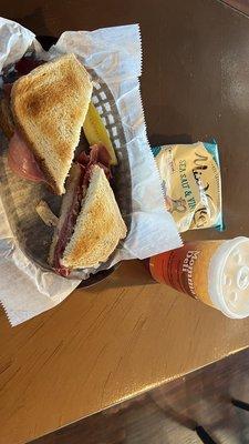 A Ruben on Sourdough, bag of Salt n Vinegar chips, sweet tea.