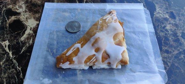 Apple turnover with a quarter for scale. $0.95.