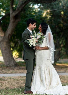 A couple holding a bouquet of flowers