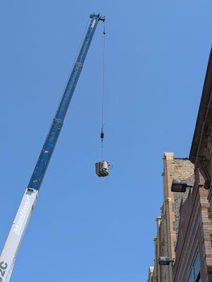 Old unit coming down from the roof.