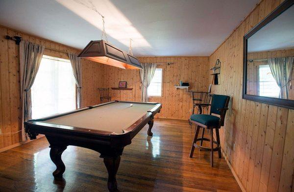 House guests can enjoy the pool room and also a BBQ on side porch overlooking the creek.