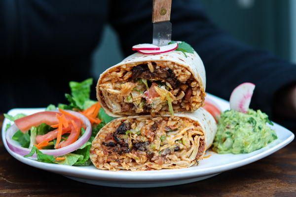 Portobello Mushroom Burrito with salad and guacamole, served Taqueria Milear style