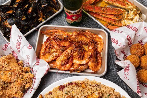 Head-on shrimp with signature sauce, fried rice, boudin balls, snow crab, mussels, and salt and pepper wings