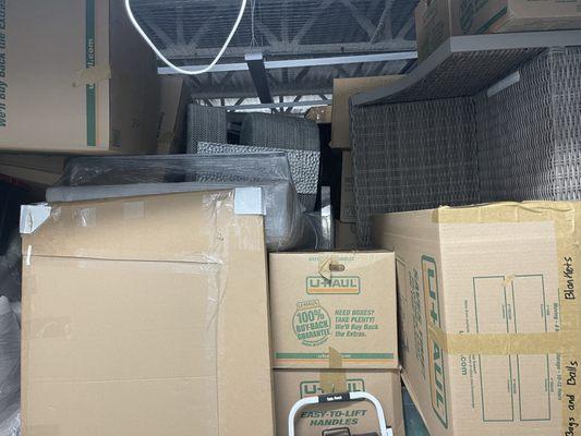 Furniture was tossed in the storage unit on top of boxes unprotected, the boxes are crushed