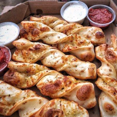 Cheesy garlic parmesan twists are a must with pizza.