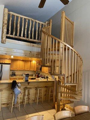 Spiral staircase going up to the loft area where the kids slept, and a shot of the fully-furnished kitchen