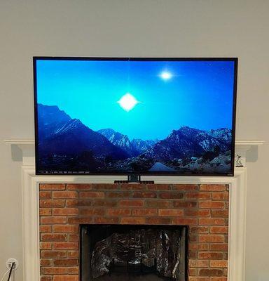 Fireplace mount bracket allows you to pull TV down pass the mantle.