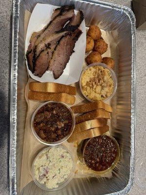 Lean brisket, hush puppies, cheesy potatoes, Texas toast, potato salad, chili with brisket, and charro beans with beef short rib.