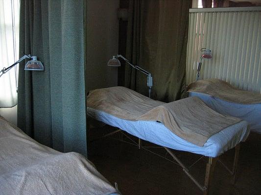 treatment spaces are separated by curtains for privacy