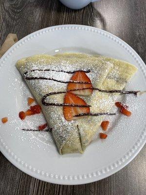 Strawberry Crepes with milk chocolate and powdered sugar