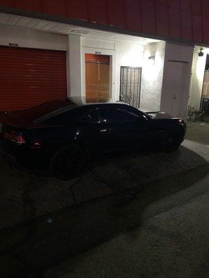 This is the black cammarro of the store manager that is always parked infront my unit.