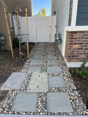 Pavers and rock extending to front of house