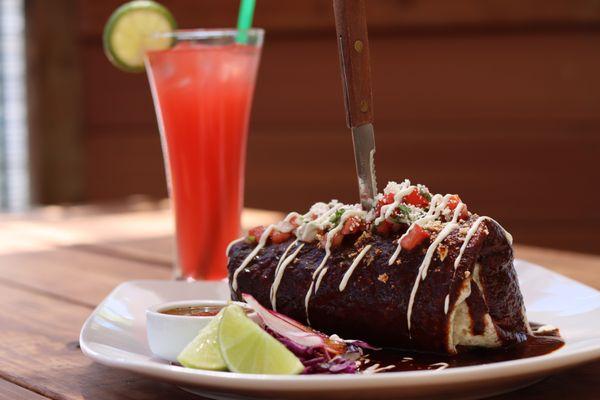 Wet burrito with protein of chioce. Choose between mole, red, or green sauce. Topped with sour cream & pico de gallo. Pair with any lemonade