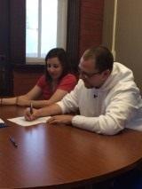 Jordan & Christa signing the paperwork!  Congratulations on the purchase of your first home!...