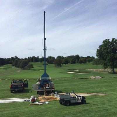 E. Garrity Water Solutions Hoist truck pulling a pump out of a well.